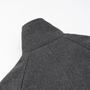 Detail of high neck collar and shoulder seams on dark grey wool coat with fine texture