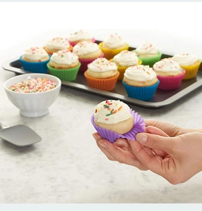 Close-up of colorful non-stick silicone cupcake liners with a cupcake in purple mold