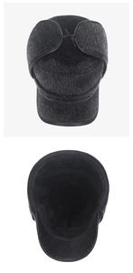 Close-up of black winter ear flap hat with thick faux fur lining and leather piping