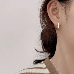 S925 sterling silver geometric rectangular hoop earrings in gold finish worn on ear