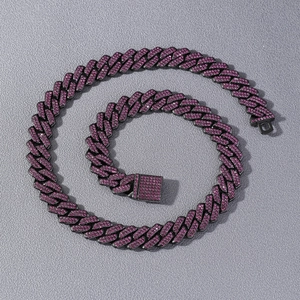Detailed macro view of black Cuban chain necklace featuring vibrant purple rhinestones
