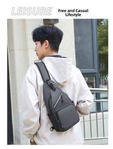Detail view of grey casual crossbody bag showing multi-compartment storage and mesh pocket
