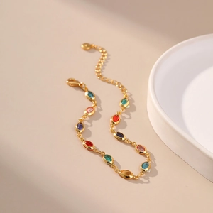 Detailed close-up of 18K gold-plated chain with colorful acrylic gemstones and lobster clasp
