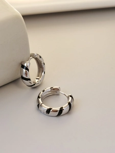 Detailed view of S925 sterling silver hoop earrings with black enamel striped texture
