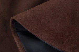 Detailed macro view of the brown faux suede fabric texture with black lining