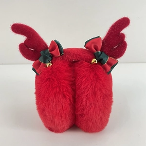 Detail of red plush Christmas earmuffs with reindeer antlers and festive golden bells
