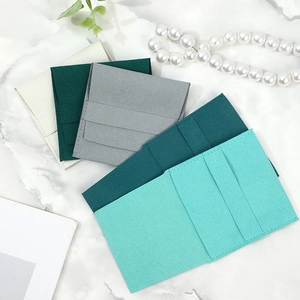 Premium microfiber jewelry pouches in various colors displayed on a marble surface