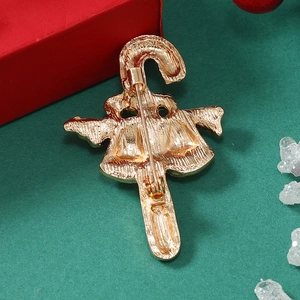 Macro shot of gold Christmas cane brooch back with detailed pin and alloy texture