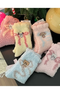 Detailed view of thick coral fleece socks with cute animal embroidery and festive decor