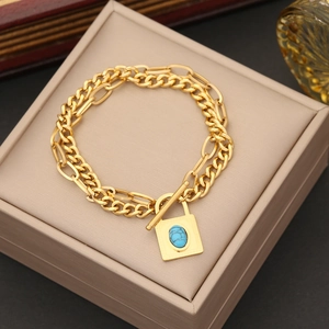 Gold-plated double layer chain bracelet featuring a turquoise stone square lock pendant