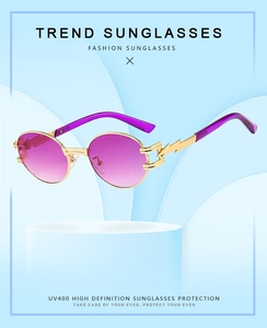 Detailed view of steampunk oval sunglasses with gold metal frame and purple gradient lenses