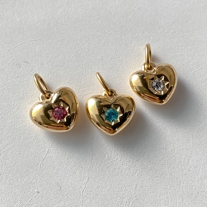 Detailed view of heart-shaped 14K gold plated pendants with colorful crystal inlays
