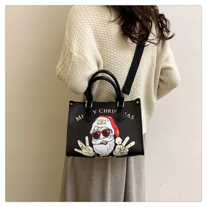Rear view of a model wearing the Christmas Santa Claus tote bag with wide fashion strap