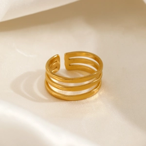 Minimalist adjustable three-layer gold titanium steel ring on elegant silk background
