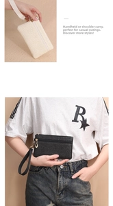 Detail der gewebten Stroh-Handgelenktasche mit Doppelreißverschluss in Beige und Schwarz