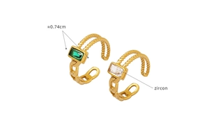 Close-up of 18K gold ring featuring emerald green and white zircons with rope texture
