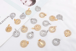 Detailed close-up of gold and silver plated hollow pendants with pavé set rhinestones