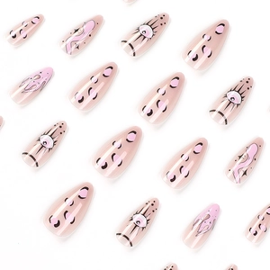 Aurora almond press-on nails with flame, eye motifs, and nude pink glossy finish