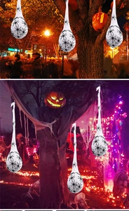 Hanging glowing Halloween spider egg sacs with black spiders for outdoor party decor