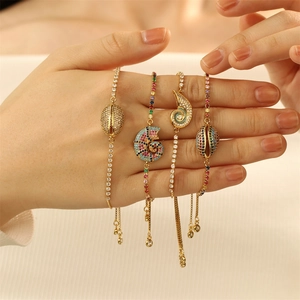 Adjustable gold plated seashell bracelets with zircon pavé and nautical charms