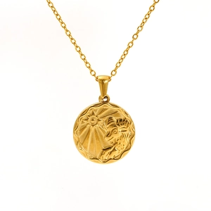 Macro detail of Aries zodiac coin pendant in gold finish with vintage sunburst texture