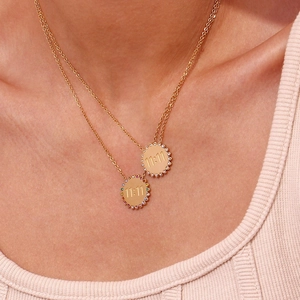 Detail of 18K gold-plated double-layer necklace with 11:11 engraved charms and gems