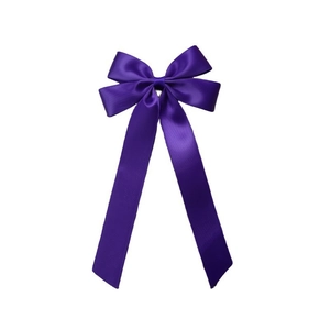 Detail of elegant dark purple satin bow with long ribbons for girl's hair accessories