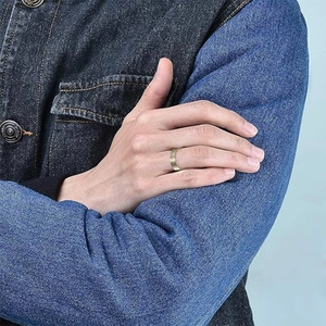 Men's two-tone stainless steel cross ring with gold and silver finish on hand