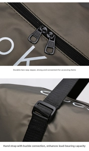 Detail of durable dual metal zippers and reinforced buckle on olive green fitness travel bag