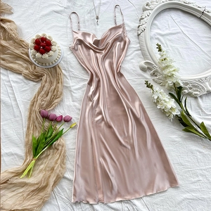 Elegant rose gold satin nightdress with cowl neck and side slit on white silk background