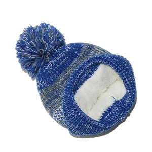 Detail of blue and gray striped knit beanie with warm white faux fleece lining and pompom