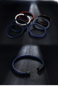 Detail of woven leather bracelets with magnetic clasps in blue, brown, red, and white