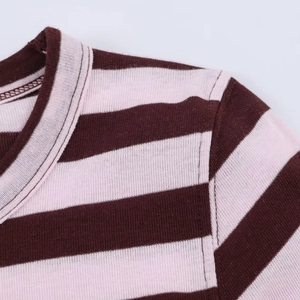 Detail of ribbed knit striped crop top showing neckline binding and shoulder stitching