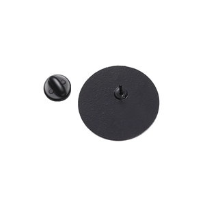 Detail view of the matte black geometric metal brooch back with secure clutch pin closure