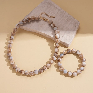 Detailed shot of ethnic acrylic marbled beads on a necklace and bracelet set