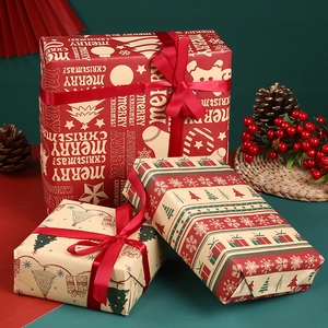 Three rolls of Christmas kraft wrapping paper with reindeer, trees, and festive ribbons