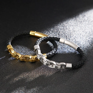 Close-up of woven leather bracelets with polished gold and silver H-link metal clasps