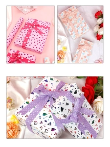 Detail of premium heart pattern gift wrap with gold foil and decorative dot ribbon