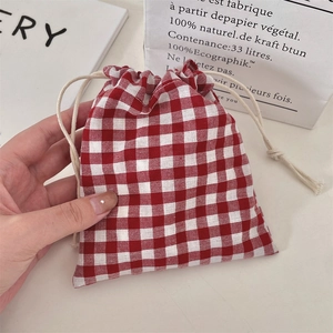 Detail of red and white checkered drawstring pouch made of linen for jewelry storage