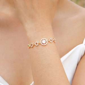 Elegant gold-tone copper bracelet for women with zircon pavé rings and central round crystal