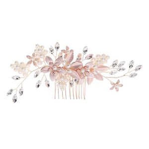 Detail of rose gold bridal hair comb with white pearls, rhinestones and delicate metal leaves