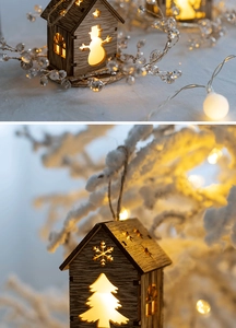 Detail of wooden Christmas house ornament with warm LED light and snowflake carving