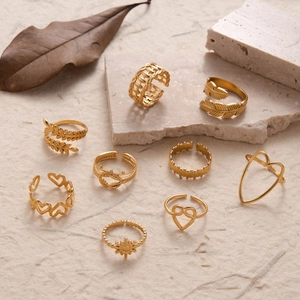 9-piece gold stainless steel ring set featuring leaf heart and sun designs
