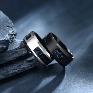 Macro detail of 8mm men's black and silver rings with blue carbon fiber inlay