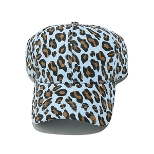 Close-up of leopard print baseball cap with light blue base and curved brim detail