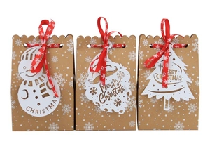 Brown kraft Christmas gift bags with laser-cut tags and red snowflake ribbons