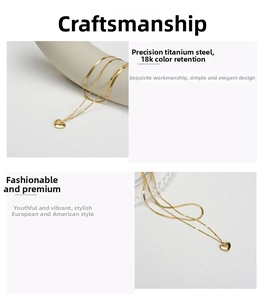 Detailed view of layered titanium steel gold necklace with heart pendant and 18k finish