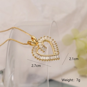 Detailed close-up of a gold-plated heart pendant necklace with white zircon inlays