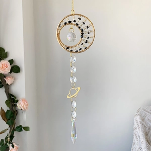Detail of golden moon suncatcher with crystal beads and Saturn charm ornament