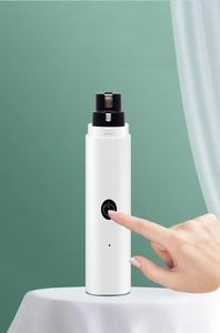 Close-up of electric pet nail grinder featuring dual-speed control button for dogs and cats